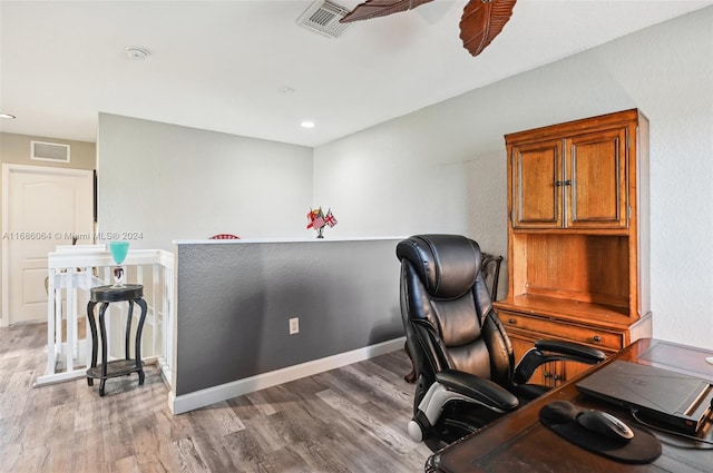 office featuring hardwood / wood-style floors and ceiling fan