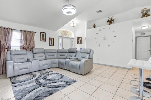 tiled cinema room featuring lofted ceiling