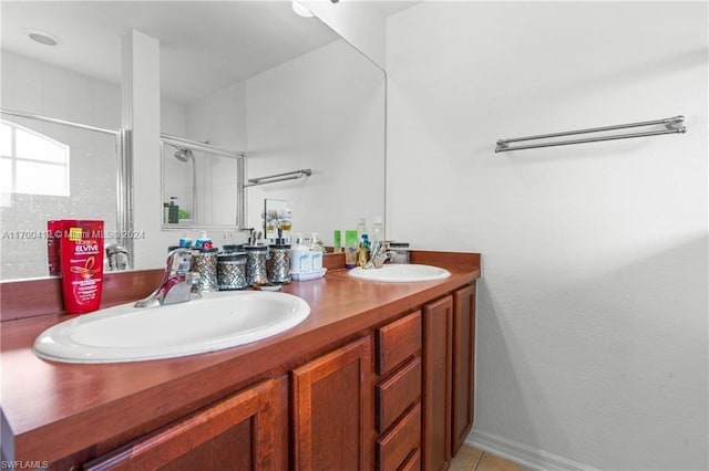 bathroom with tile patterned flooring, vanity, and an enclosed shower