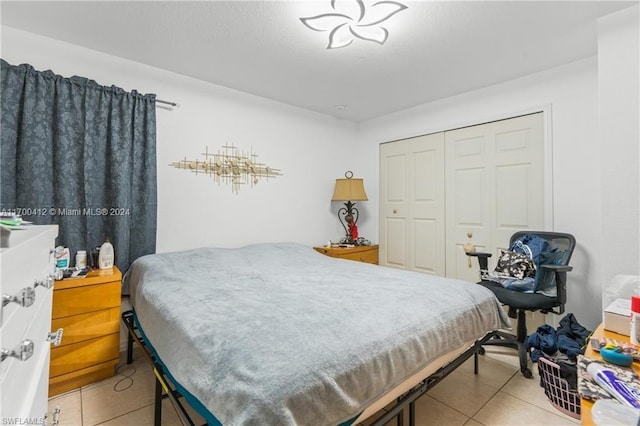 bedroom featuring a closet and light tile patterned floors