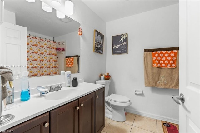 bathroom featuring tile patterned flooring, vanity, and toilet