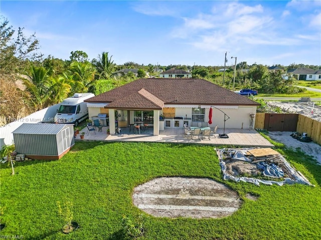 back of house with a lawn and a patio area