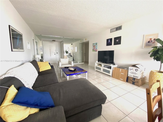 living room with light tile patterned floors and a textured ceiling