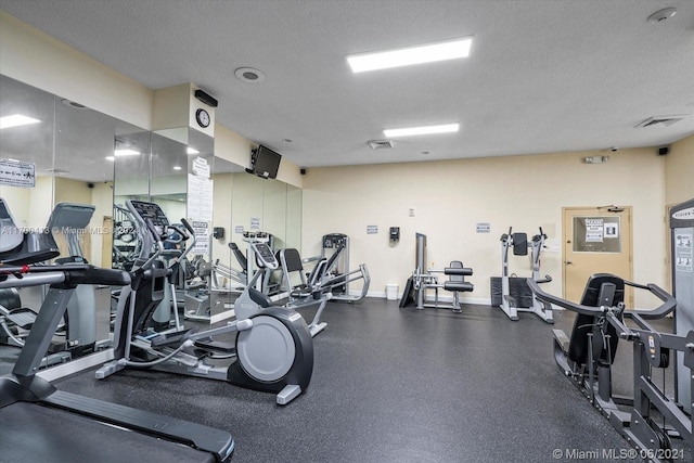 workout area featuring a textured ceiling