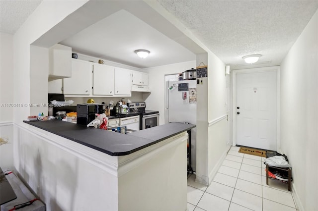 kitchen featuring kitchen peninsula, a textured ceiling, light tile patterned floors, white cabinets, and stainless steel range with electric cooktop