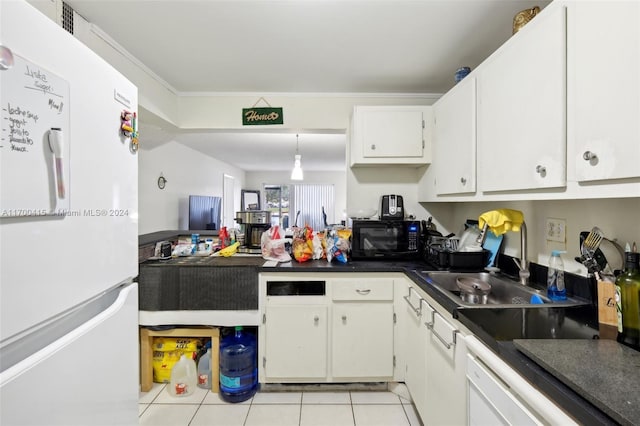 kitchen with sink, light tile patterned flooring, white refrigerator, crown molding, and white cabinets