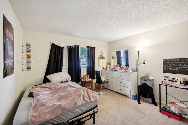 bedroom with light carpet and a textured ceiling