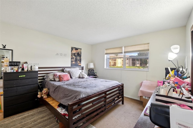 carpeted bedroom featuring a textured ceiling