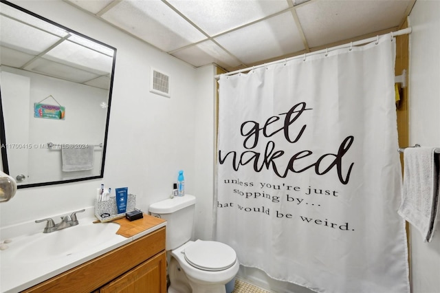 bathroom featuring a paneled ceiling, vanity, a shower with shower curtain, and toilet