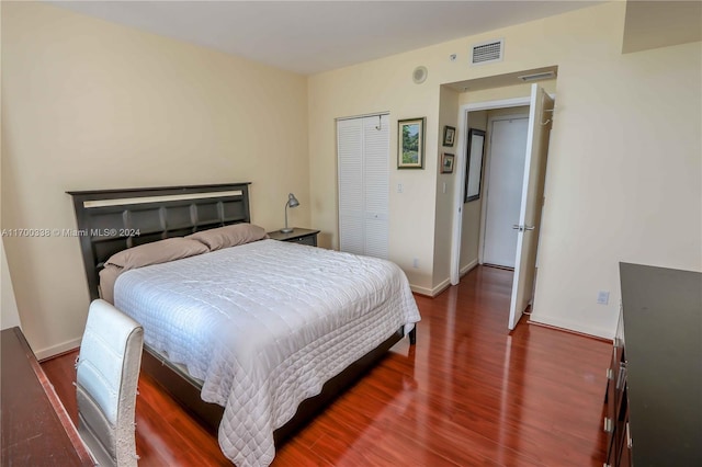 bedroom featuring dark wood-type flooring and a closet