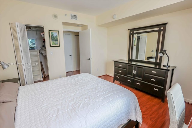 bedroom with a closet and hardwood / wood-style flooring