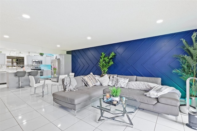 tiled living room with breakfast area and wood walls