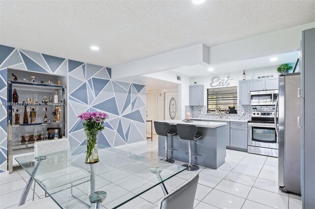 dining room featuring sink and a textured ceiling