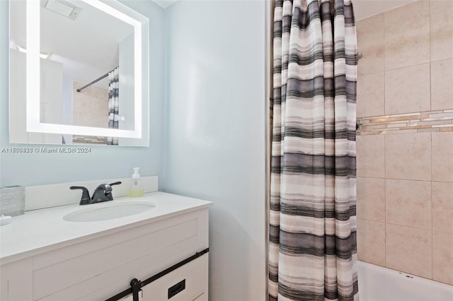 bathroom featuring vanity and shower / bath combination with curtain