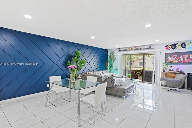 dining area featuring a textured ceiling and light tile patterned flooring