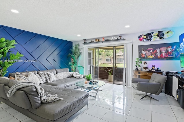 tiled living room featuring a textured ceiling