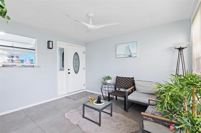 interior space with tile patterned floors and ceiling fan