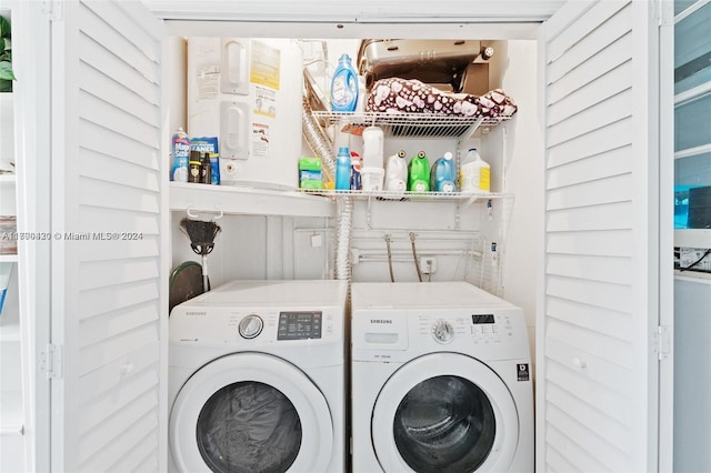 clothes washing area with washing machine and clothes dryer