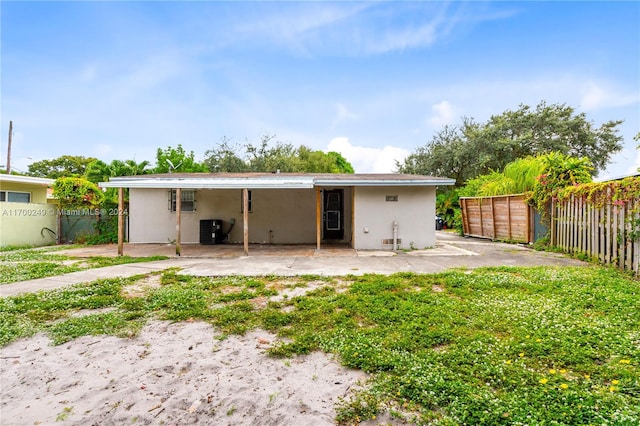 back of property featuring central AC