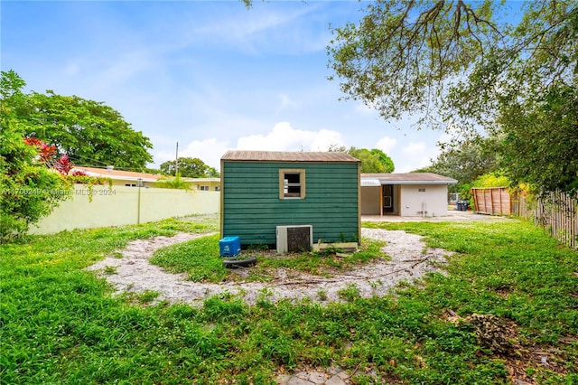 rear view of property with an outdoor structure