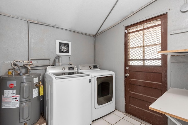 clothes washing area featuring light tile patterned floors, electric water heater, and washing machine and dryer