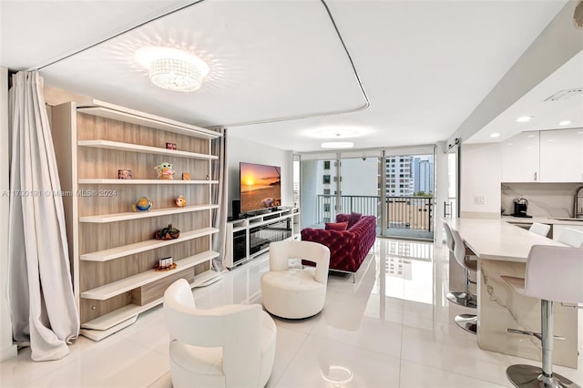 tiled living room with a wall of windows and sink