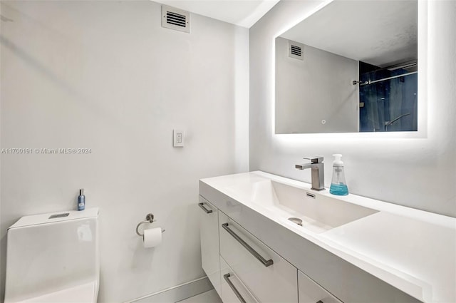 bathroom featuring a shower, vanity, and toilet