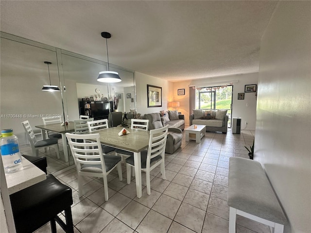 dining area with light tile patterned flooring and a textured ceiling