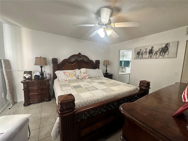 tiled bedroom with ceiling fan, ensuite bathroom, and a textured ceiling