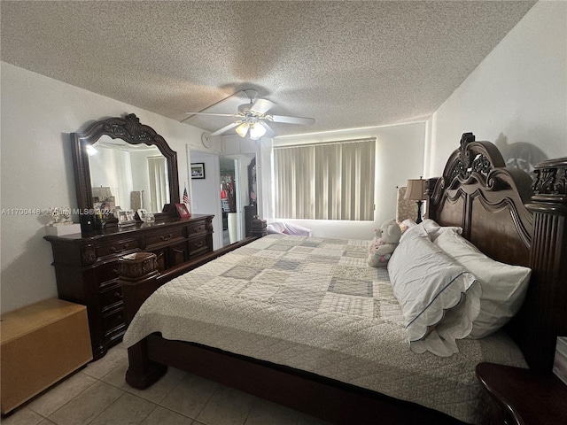 tiled bedroom featuring ceiling fan and a textured ceiling