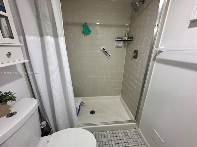 bathroom featuring walk in shower, tile patterned flooring, and toilet