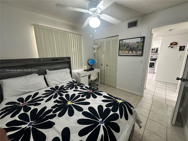 tiled bedroom featuring ceiling fan and a closet