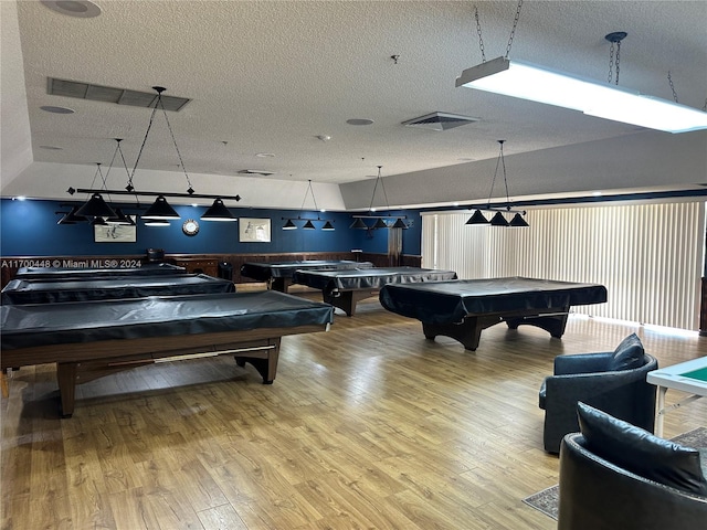 rec room with a textured ceiling, hardwood / wood-style flooring, and pool table