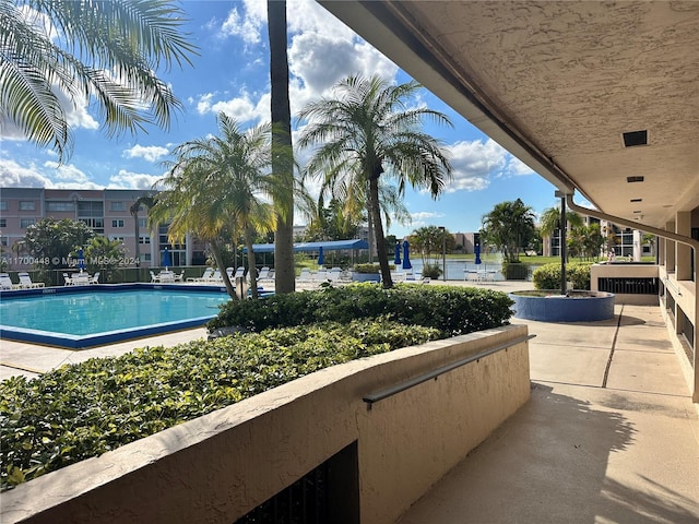 view of pool featuring a water view