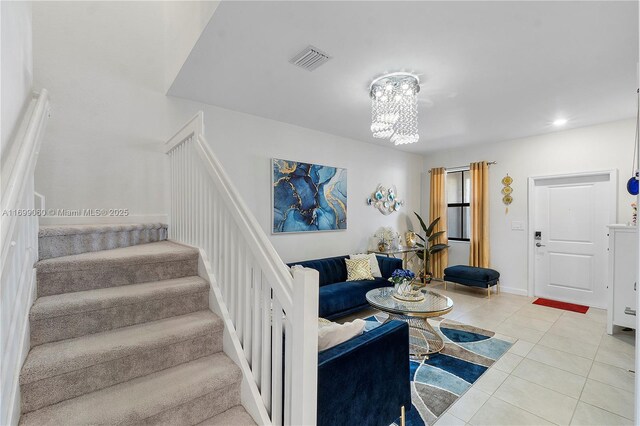 tiled living room with an inviting chandelier