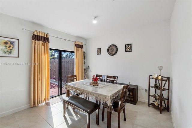 dining space featuring light tile patterned floors