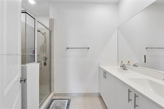 bathroom with vanity, tile patterned floors, and a shower with shower door