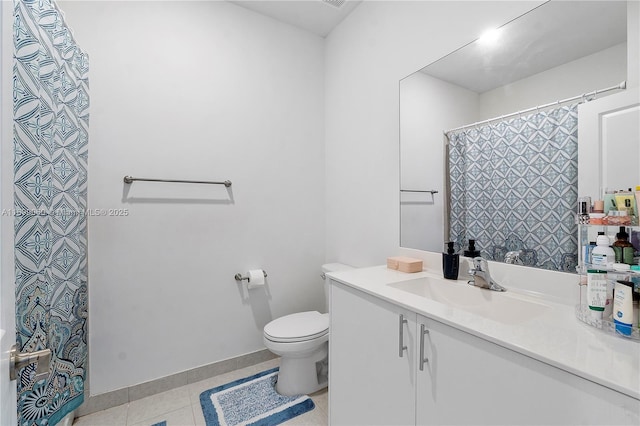 bathroom featuring vanity, tile patterned flooring, and toilet