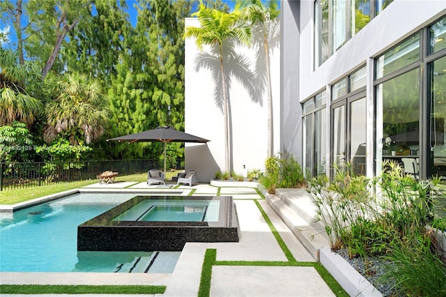 view of pool featuring a patio area and an in ground hot tub