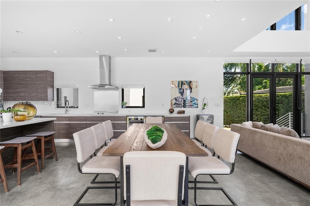 dining room featuring wine cooler, french doors, and sink