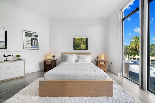 bedroom with concrete flooring and access to outside