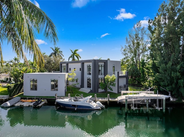 exterior space with a water view and a lawn