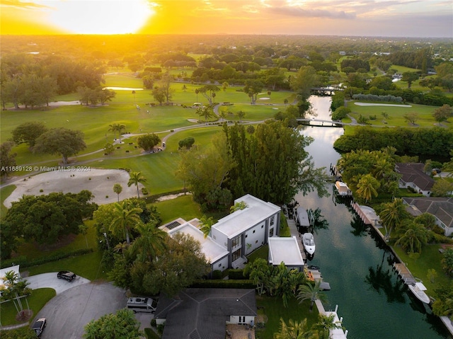 aerial view at dusk featuring a water view