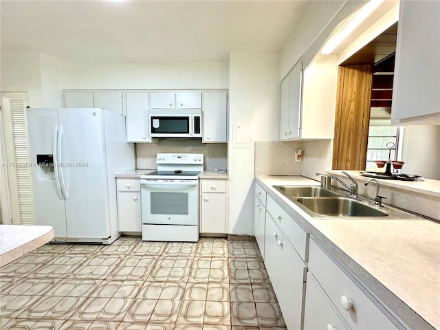 kitchen featuring white cabinets, decorative backsplash, white appliances, and sink