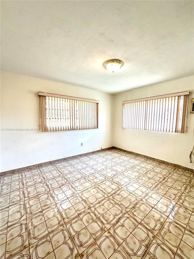 spare room with a textured ceiling