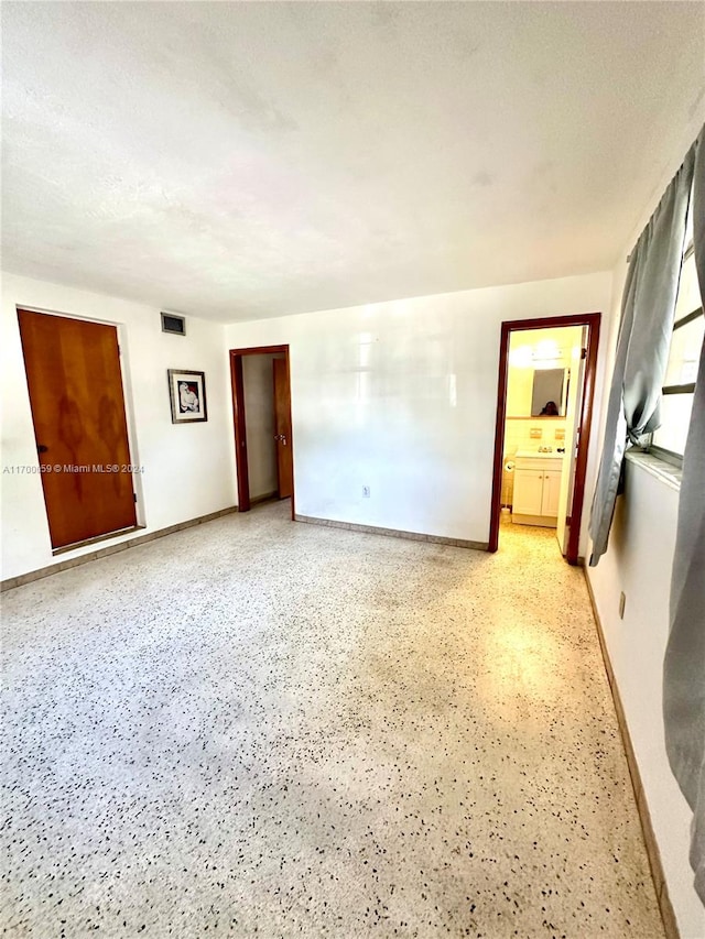 unfurnished room featuring a textured ceiling