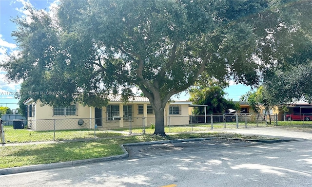 view of front facade with central AC and a front lawn