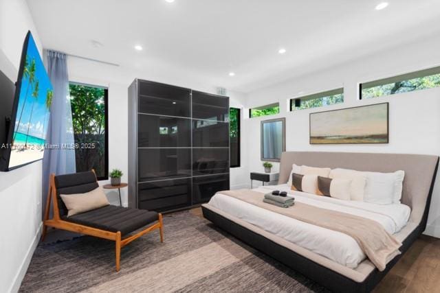 bedroom featuring wood-type flooring and multiple windows