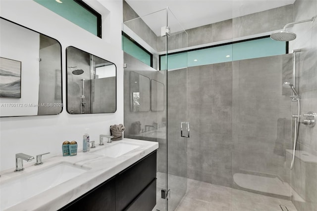 bathroom featuring an enclosed shower and vanity