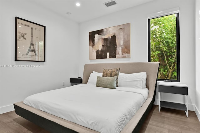 bedroom with hardwood / wood-style floors